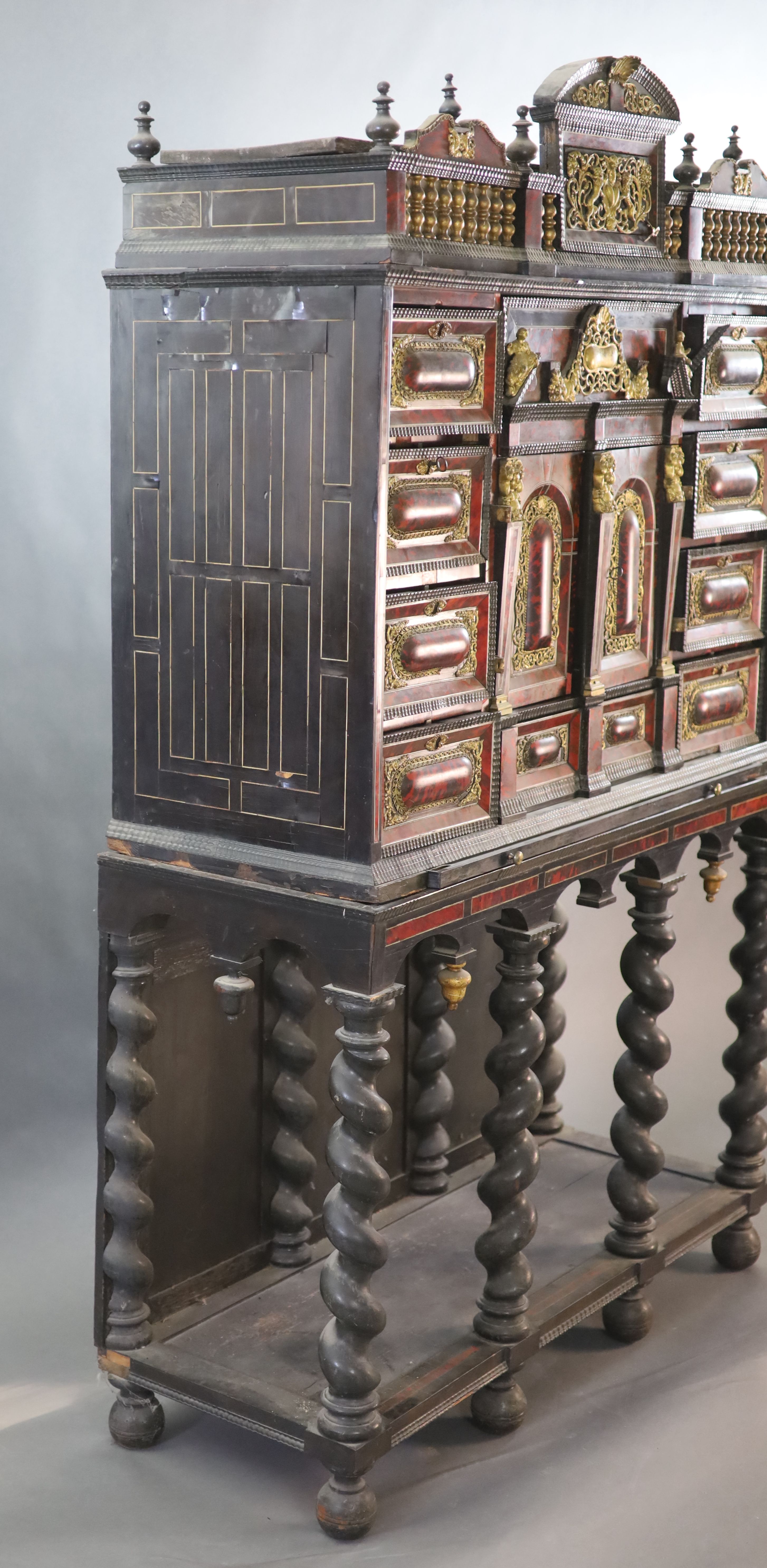 A late 17th century Portuguese ormolu mounted ebony and red tortoiseshell cabinet on stand, W.124cm D.46cm H.187cm